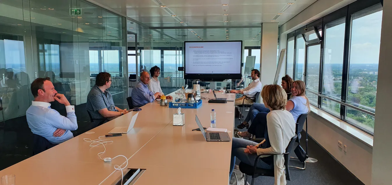 The Nxus and Radboud teams (me included) having a meeting in a shiny conference room inside Radboud's skyscraper.